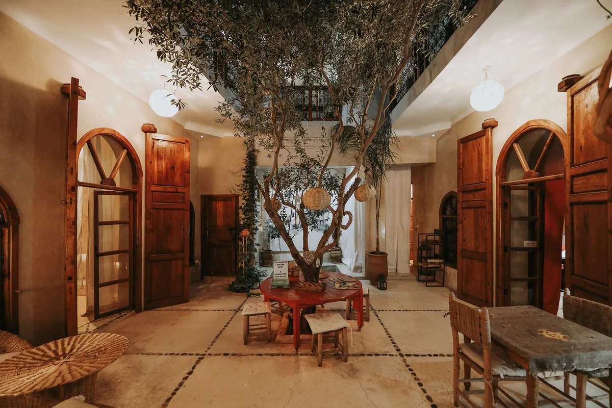 The riad's sunlit patio, the pool and the bhous around it